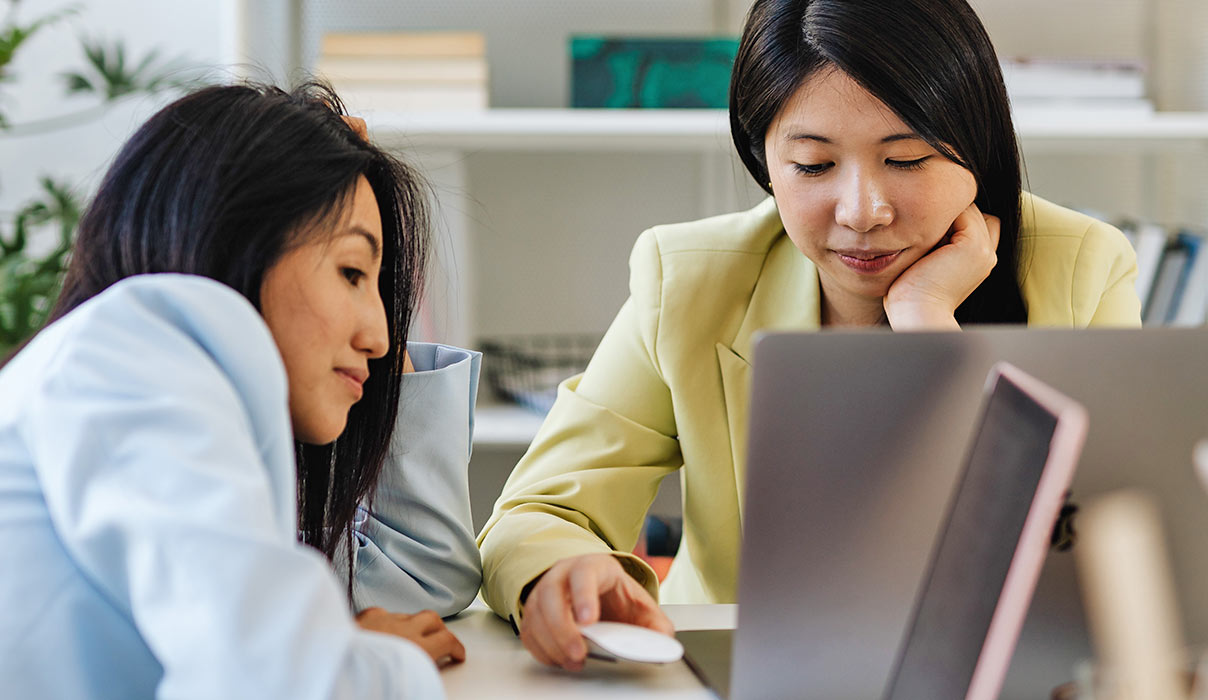 two women looking at laptop